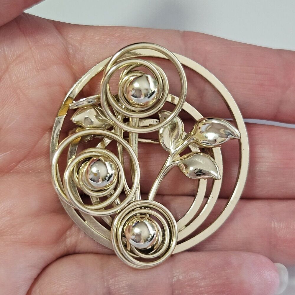 Gold tone circular brooch abstract flowers